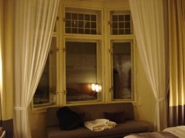 Window side seating area with electrically powered curtains