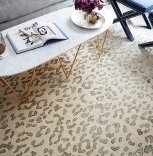 A leopard rug in a soft palette defines the open seating area and makes it feel like a true living space of its own.