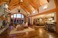 A rustic wood great room with cavernous cathedral ceilings.