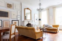 A tall and slender antique mirror tops the mantel in the West Village home of Alison Cayne.