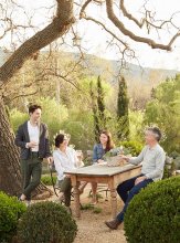 Brooke and Steve relax with two of their children in the alfresco dining area. “We wanted the outdoor spaces to be real rooms, an extension of what is inside the home, ” says Brooke.