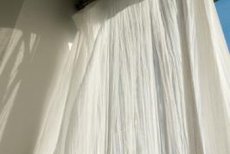 Flowing curtain panels add a sense of space to any small area.